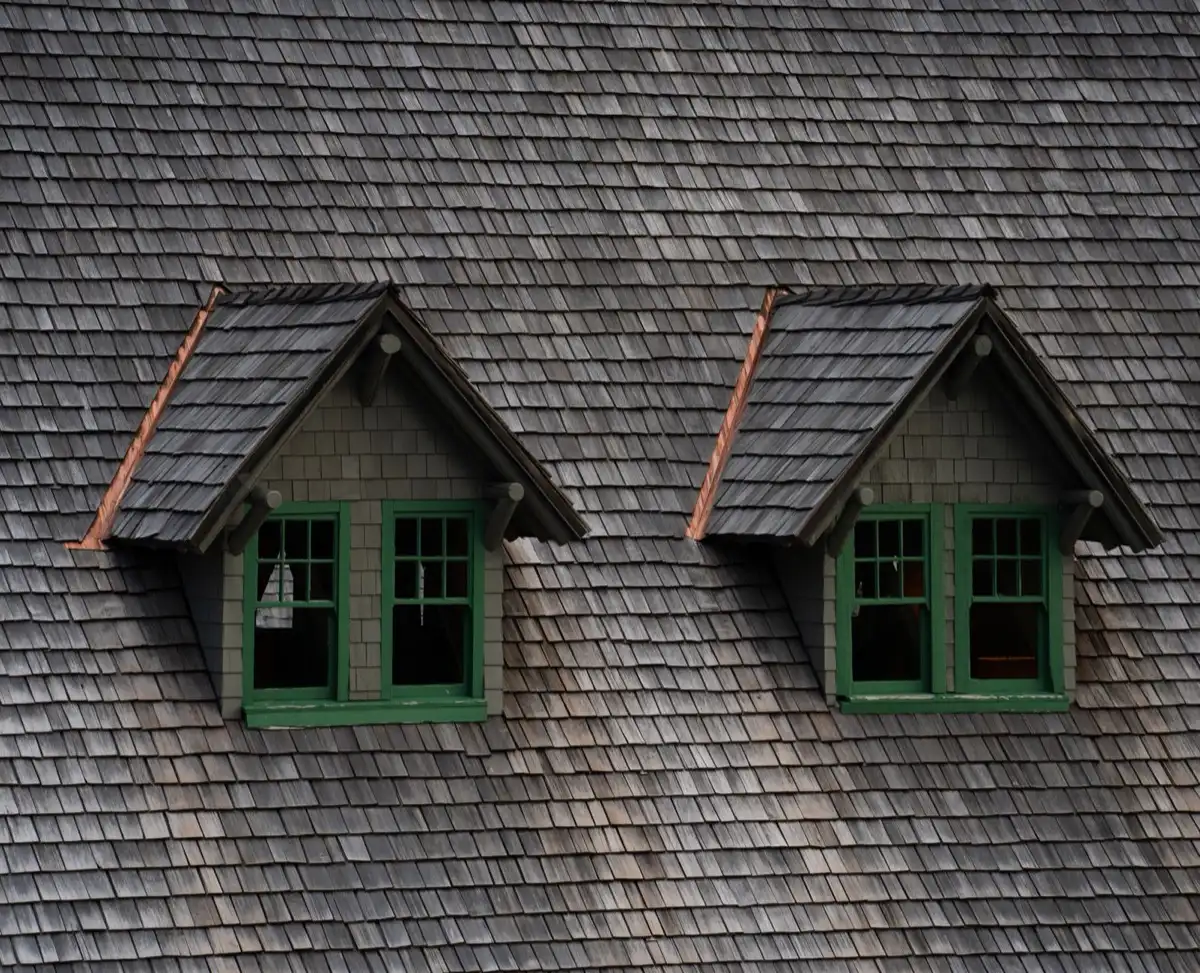 Dormers on a shingle roof in Anchorage, AK, where step flashing and kickout flashing carry water past the walls